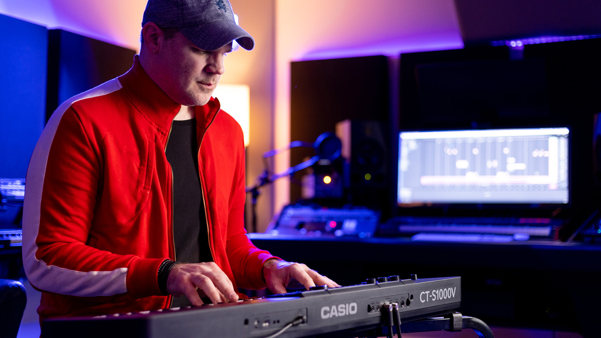 Man in recording studio playing Casiotone keyboard